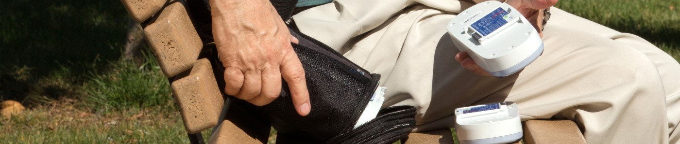 Man changing the battery of his OxyGo Portable Oxygen Concentrator