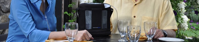 Couple out to dinner while using the OxyGo portable oxygen concentrator
